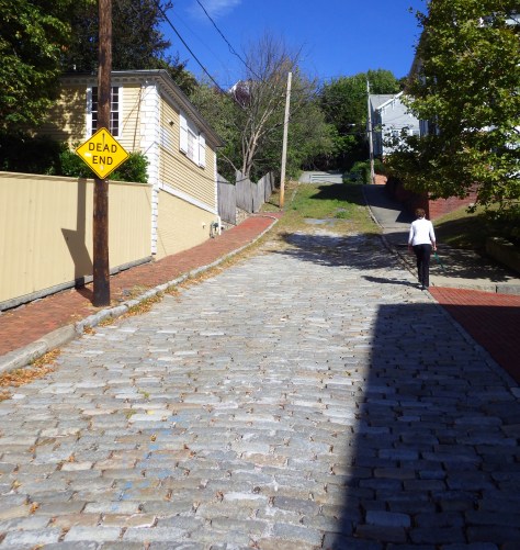 Tiff hiking up the steep roads from the Visitor Center to the Memorial